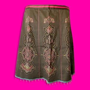 Green skirt with pink and green embroidery.